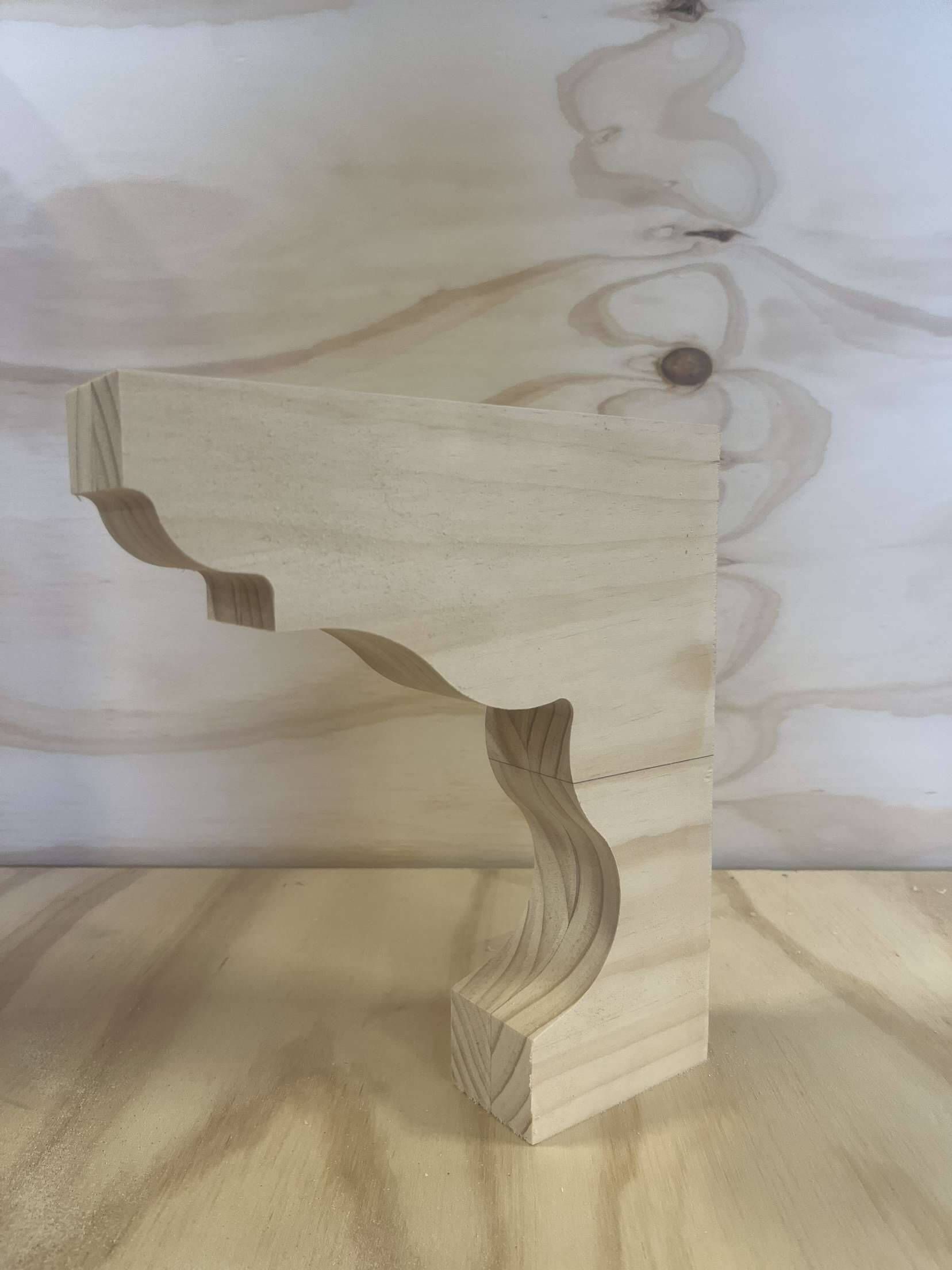 A piece of wood is sitting on top of a wooden table.Precision Woodworks