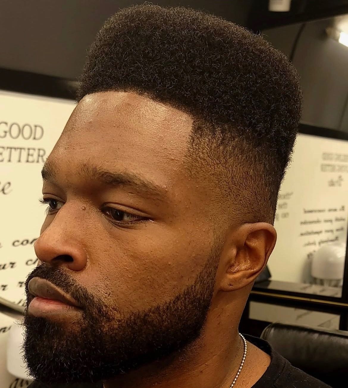 A man with a beard is wearing a black shirt