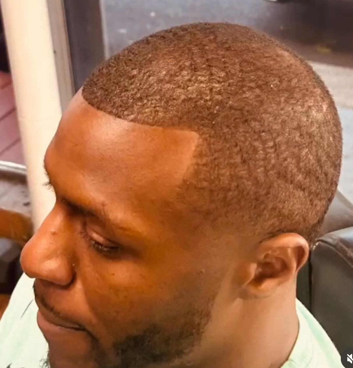 A close up of a man 's head with a beard