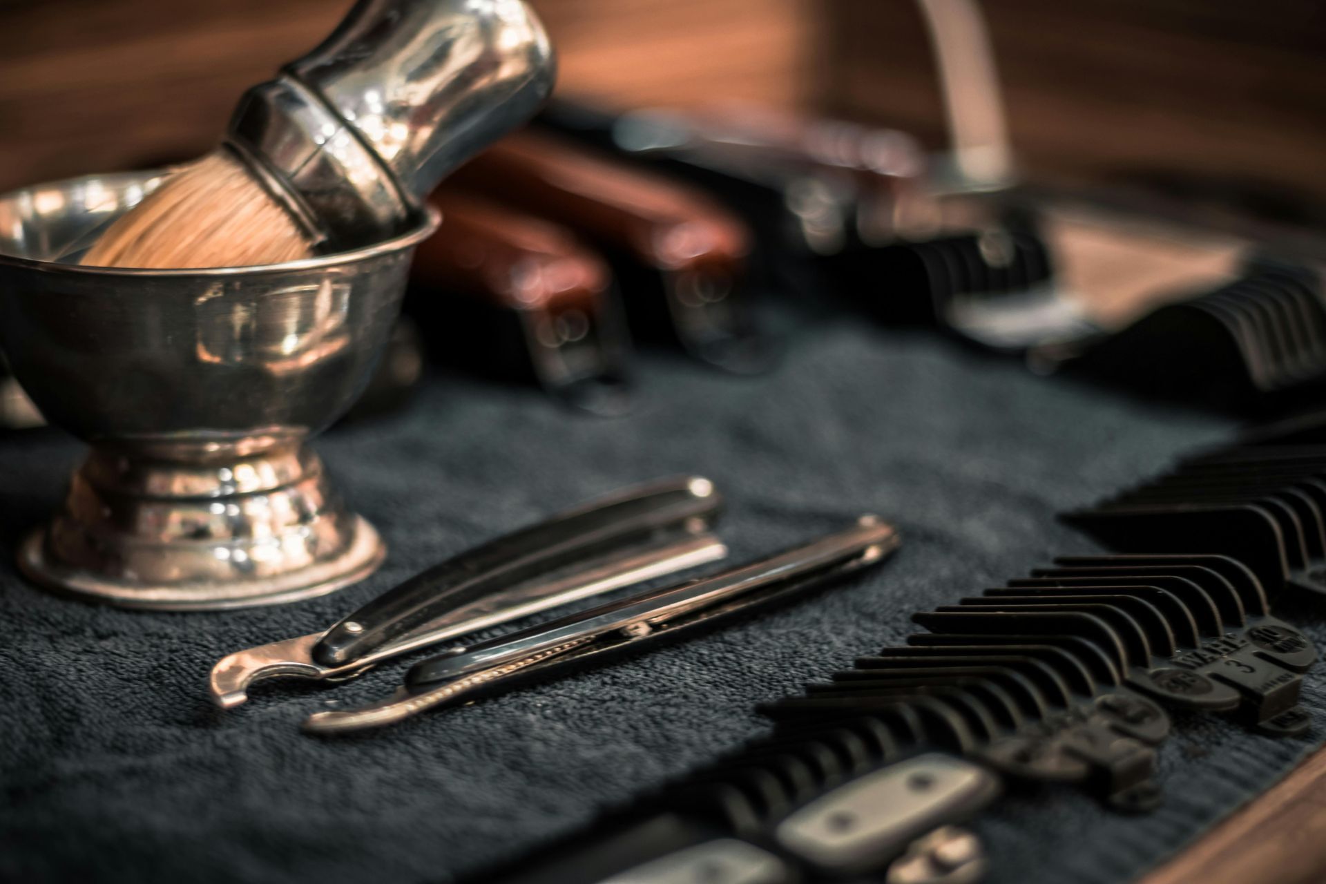 A shaving brush is sitting on top of a table next to a bowl of shaving cream.