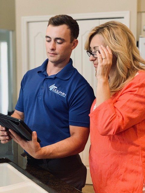 Water Heater Expert — Repairman Showing Information To Customer in Fort Myers, FL