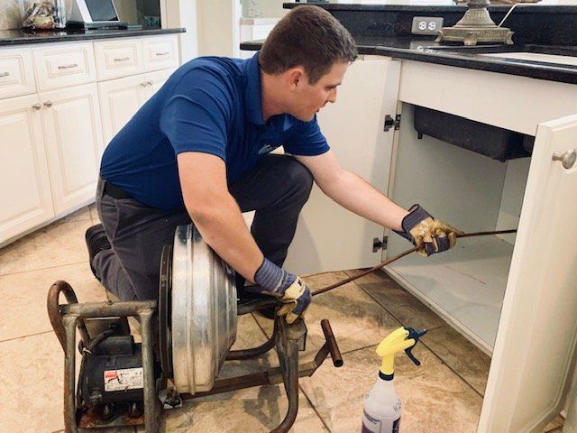 Drain Cleaning Expert — Plumber Working On Drain in Fort Myers, FL