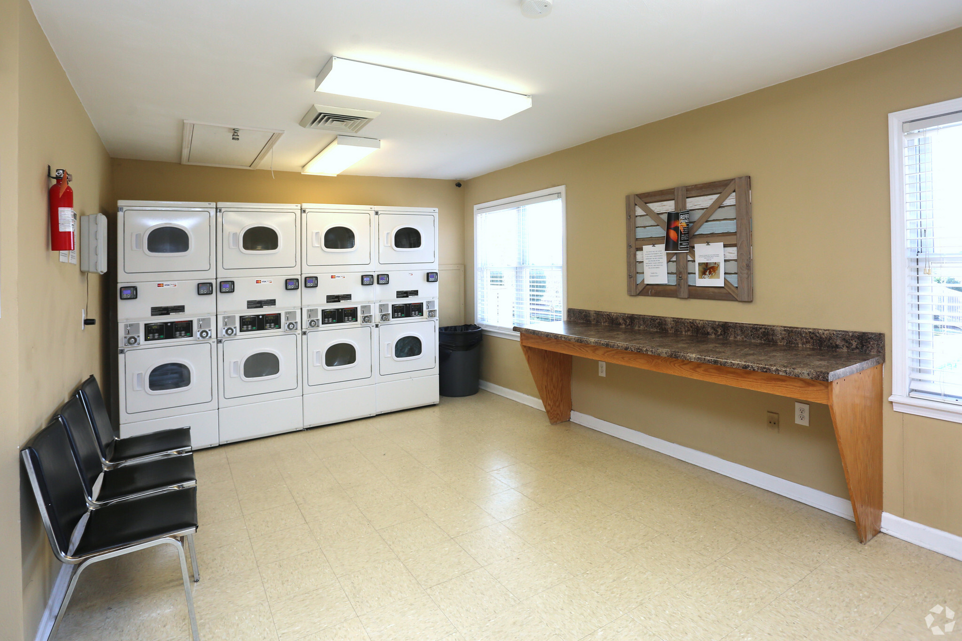 laundy room with a lot of washers and dryers.