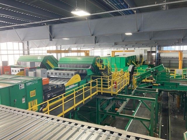 A warehouse with a lot of green and yellow machinery