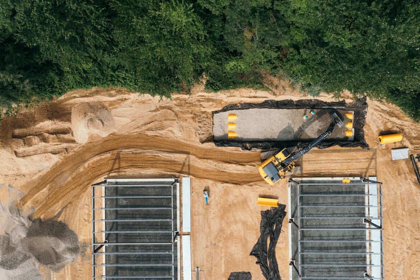 An aerial view of a construction site with a bulldozer moving dirt.