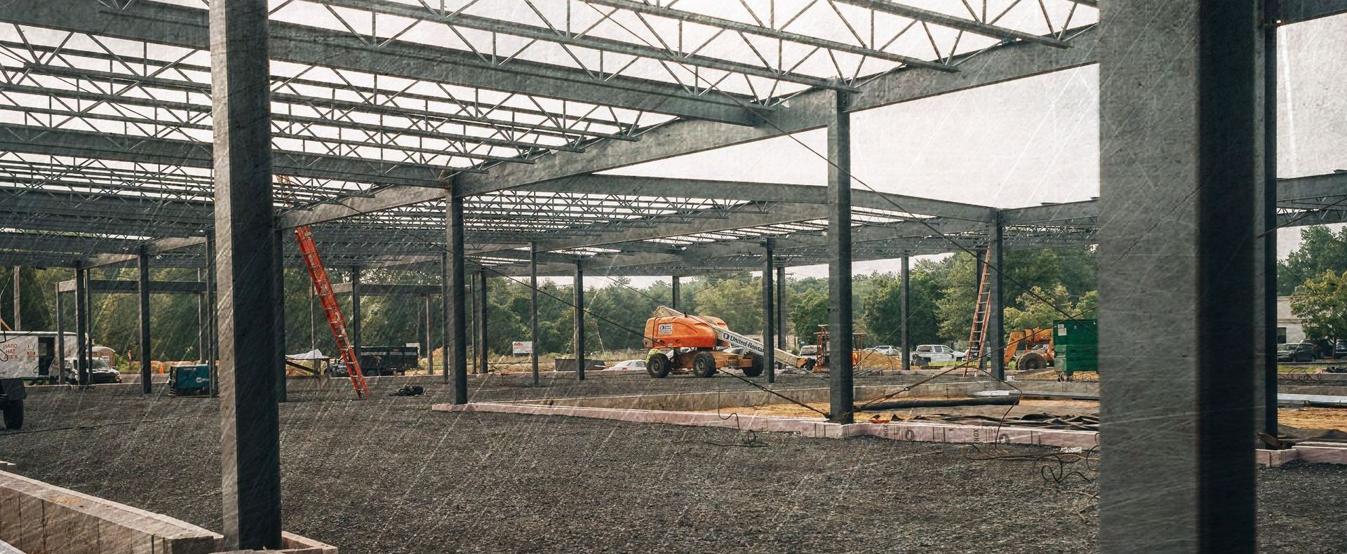 A large building under construction with a lot of steel beams.