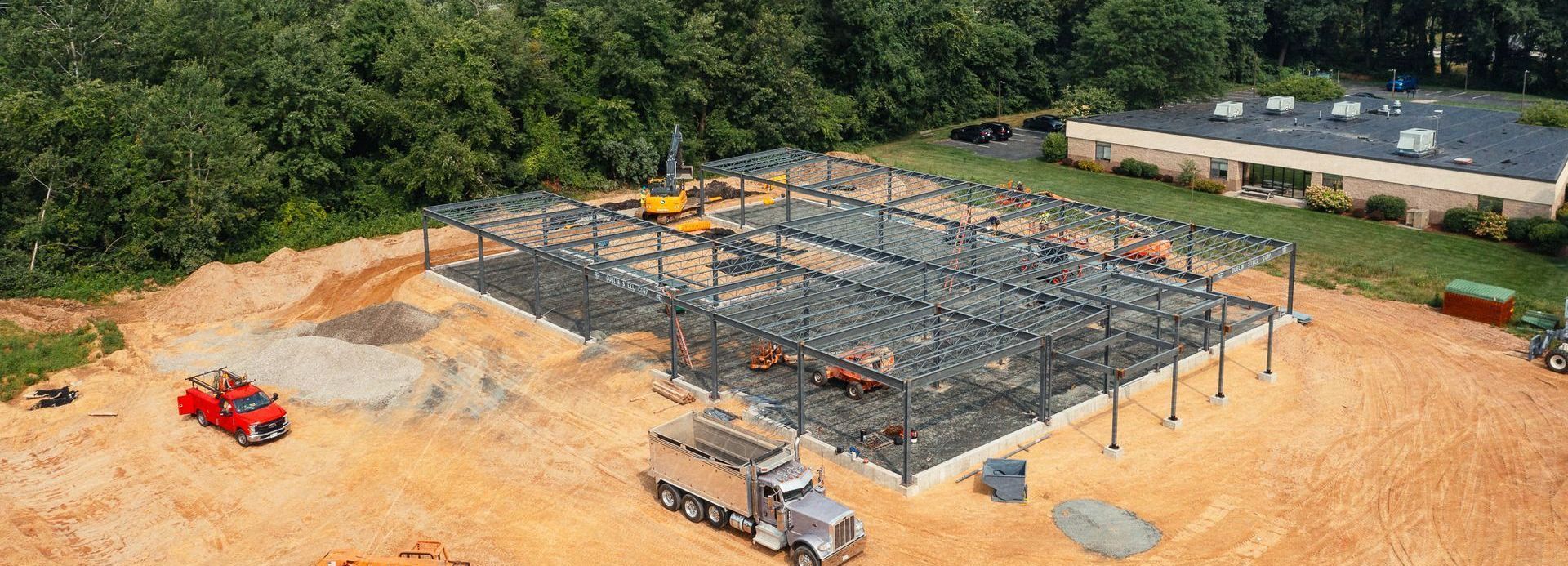 An aerial view of a construction site with a truck parked in the dirt.