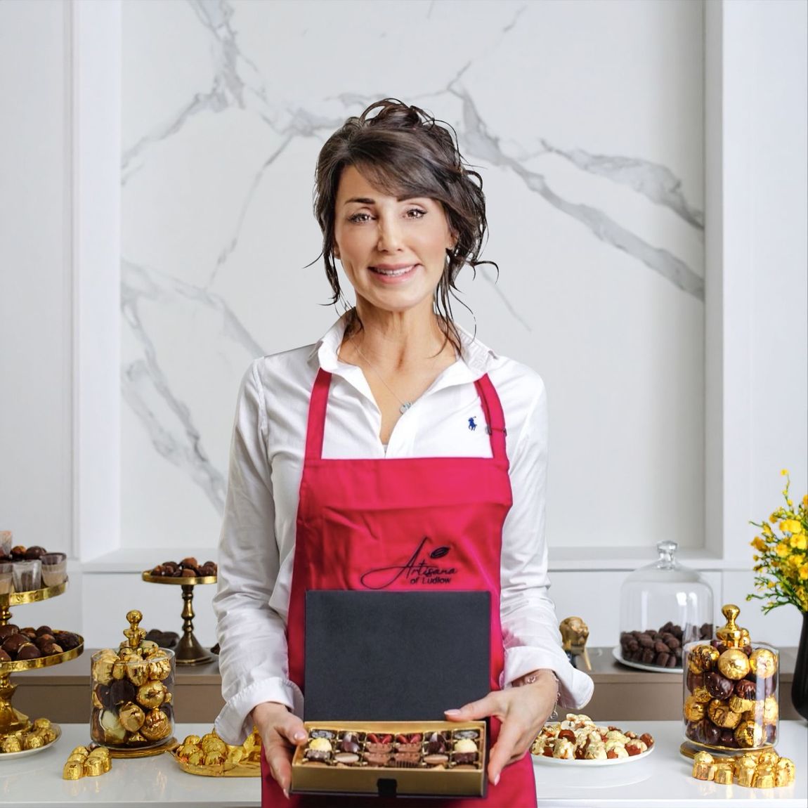 An image of Karin holding a box of Artisana chocolates