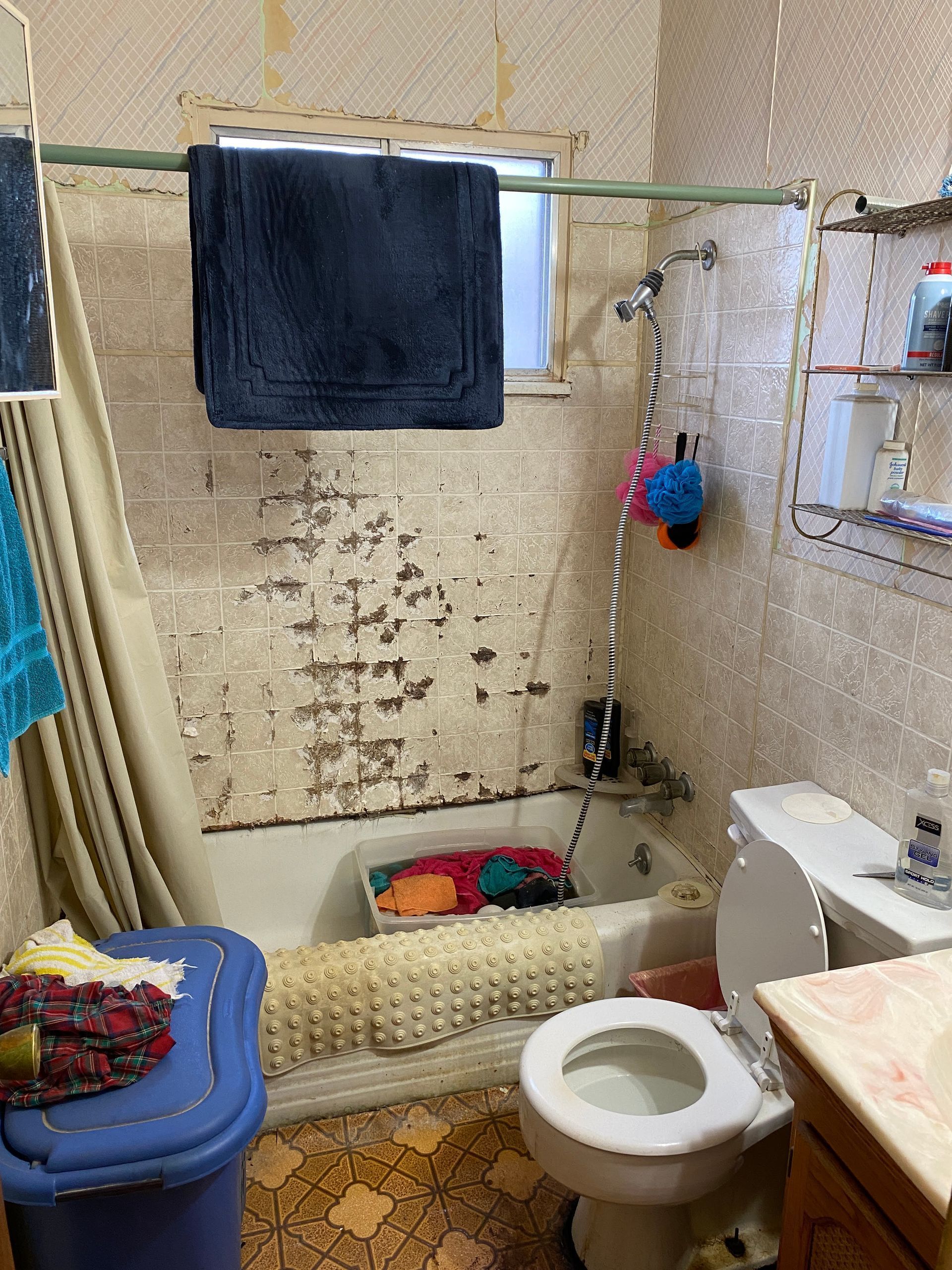 A bathroom with a toilet , bathtub , sink and mirror.