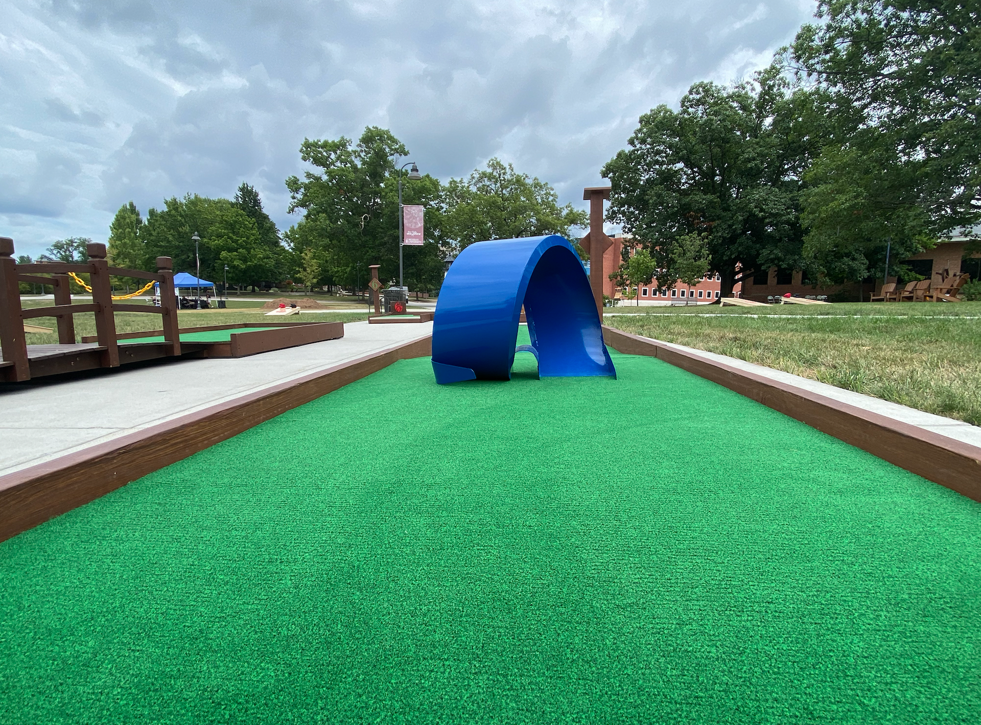 A small golf course with a blue arch in the middle of it.