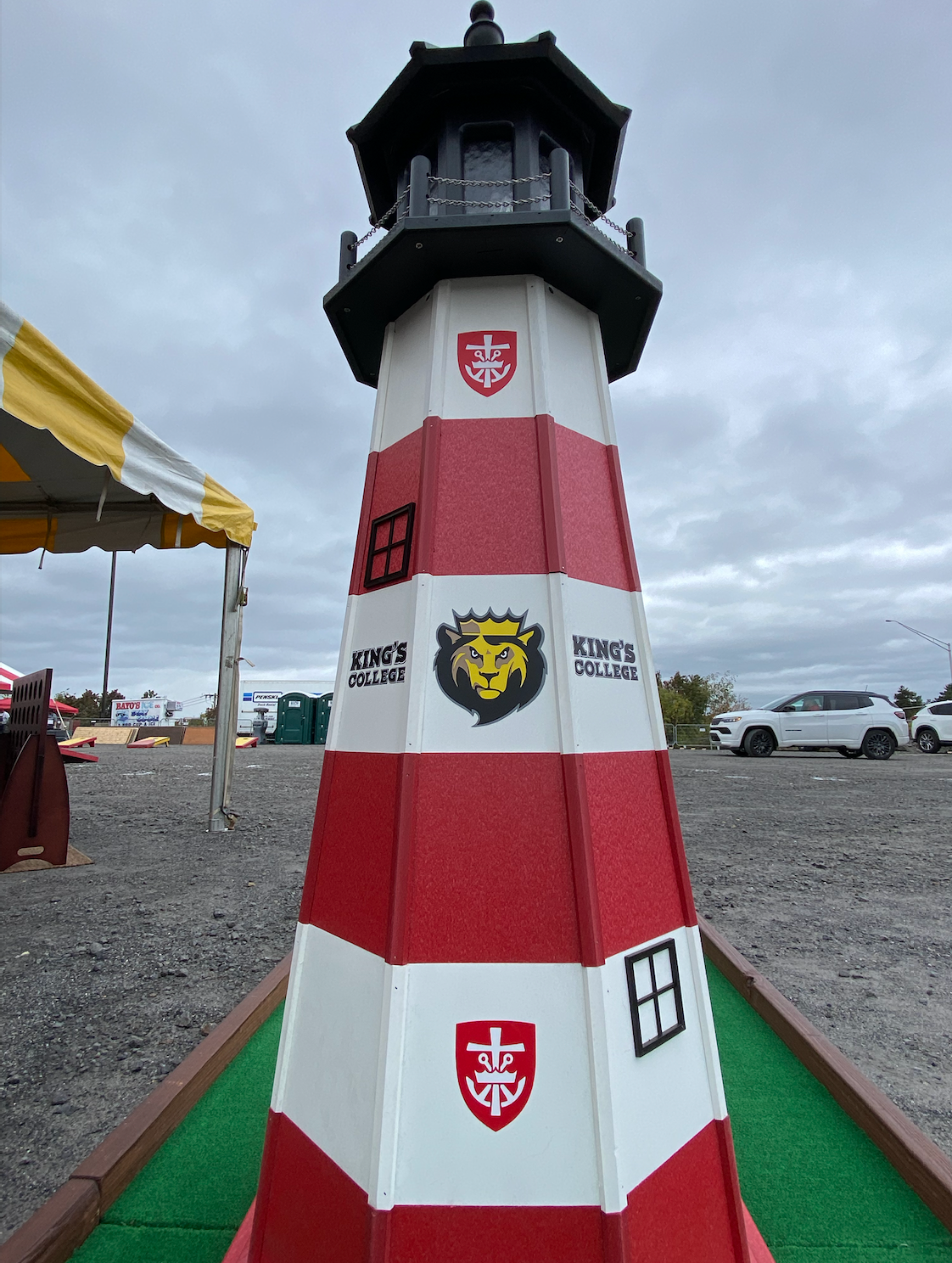 A red and white lighthouse with a lion on it