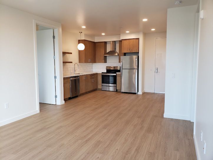 A kitchen with stainless steel appliances and wooden cabinets