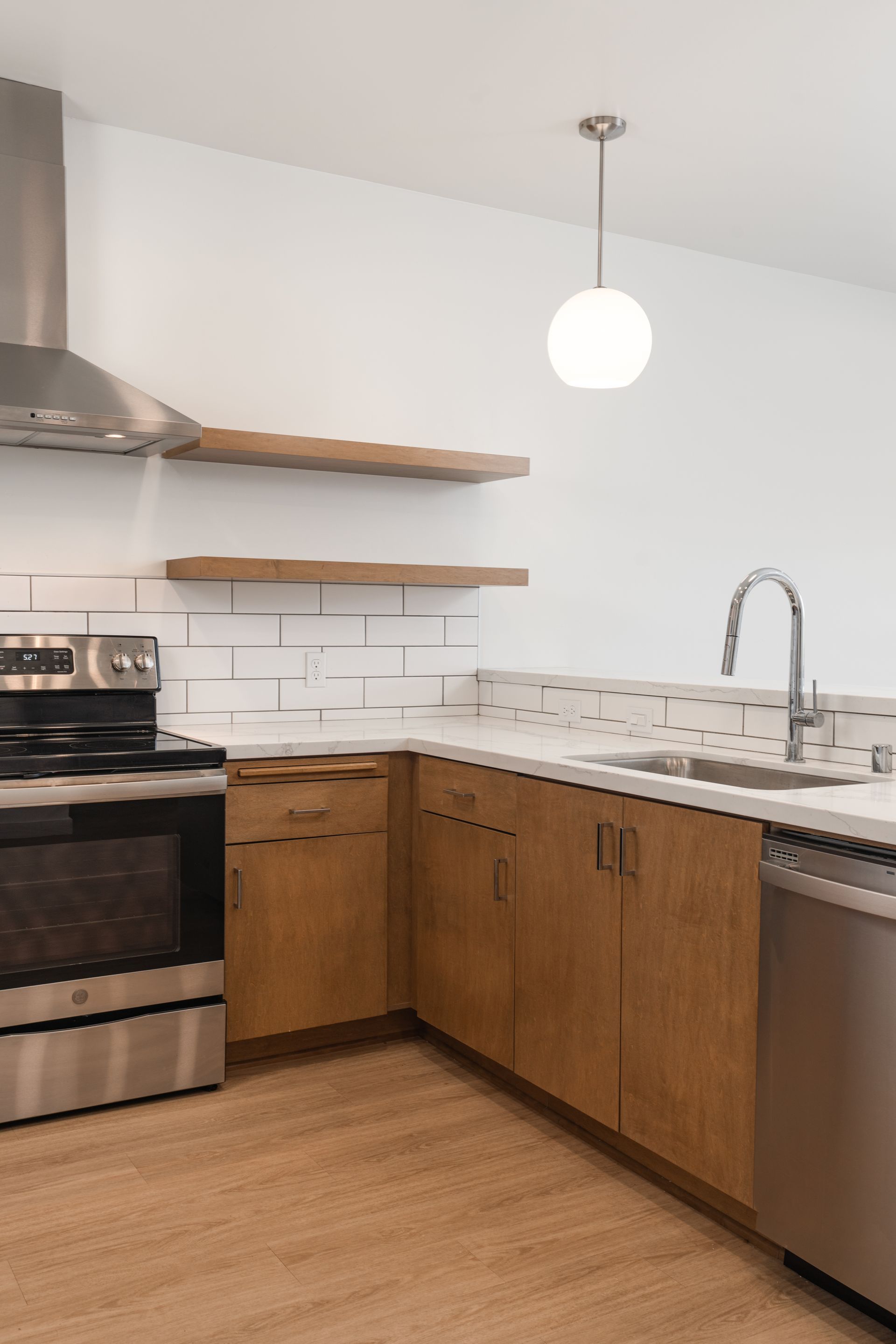 A kitchen with stainless steel appliances and wooden cabinets