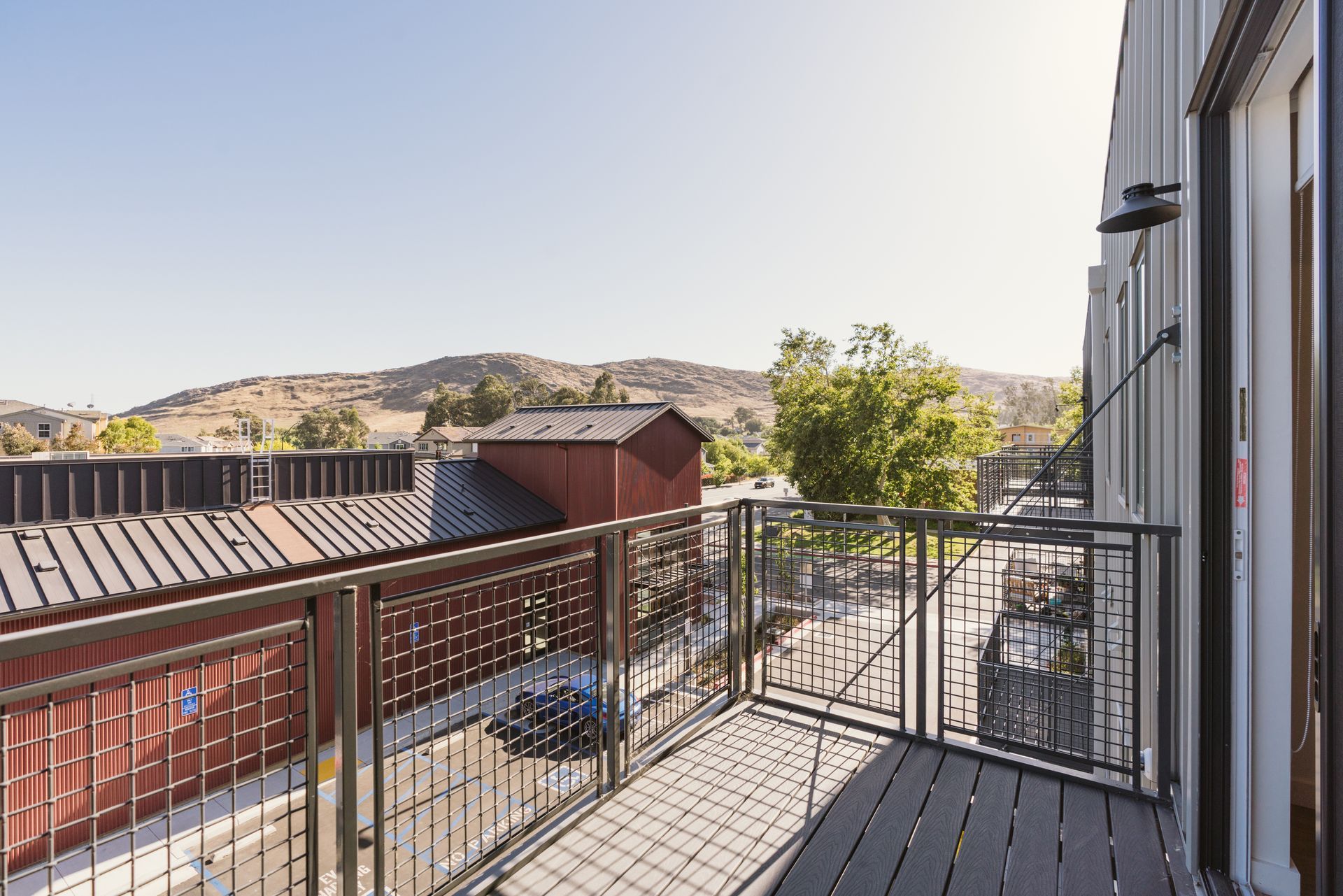 A balcony with a view of a city and mountains.