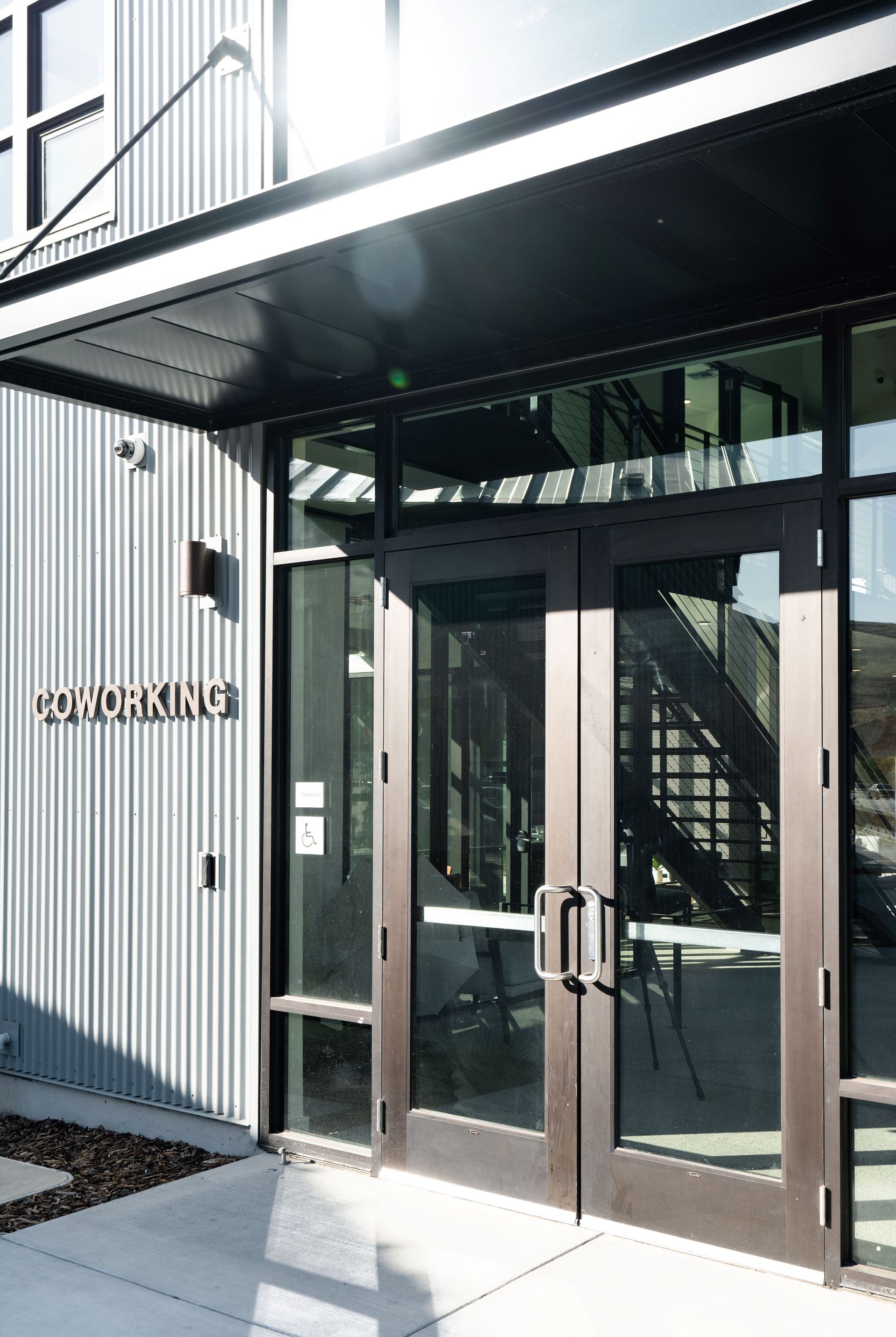 The entrance to a building with a staircase and a sign that says ' downtown ' on it.