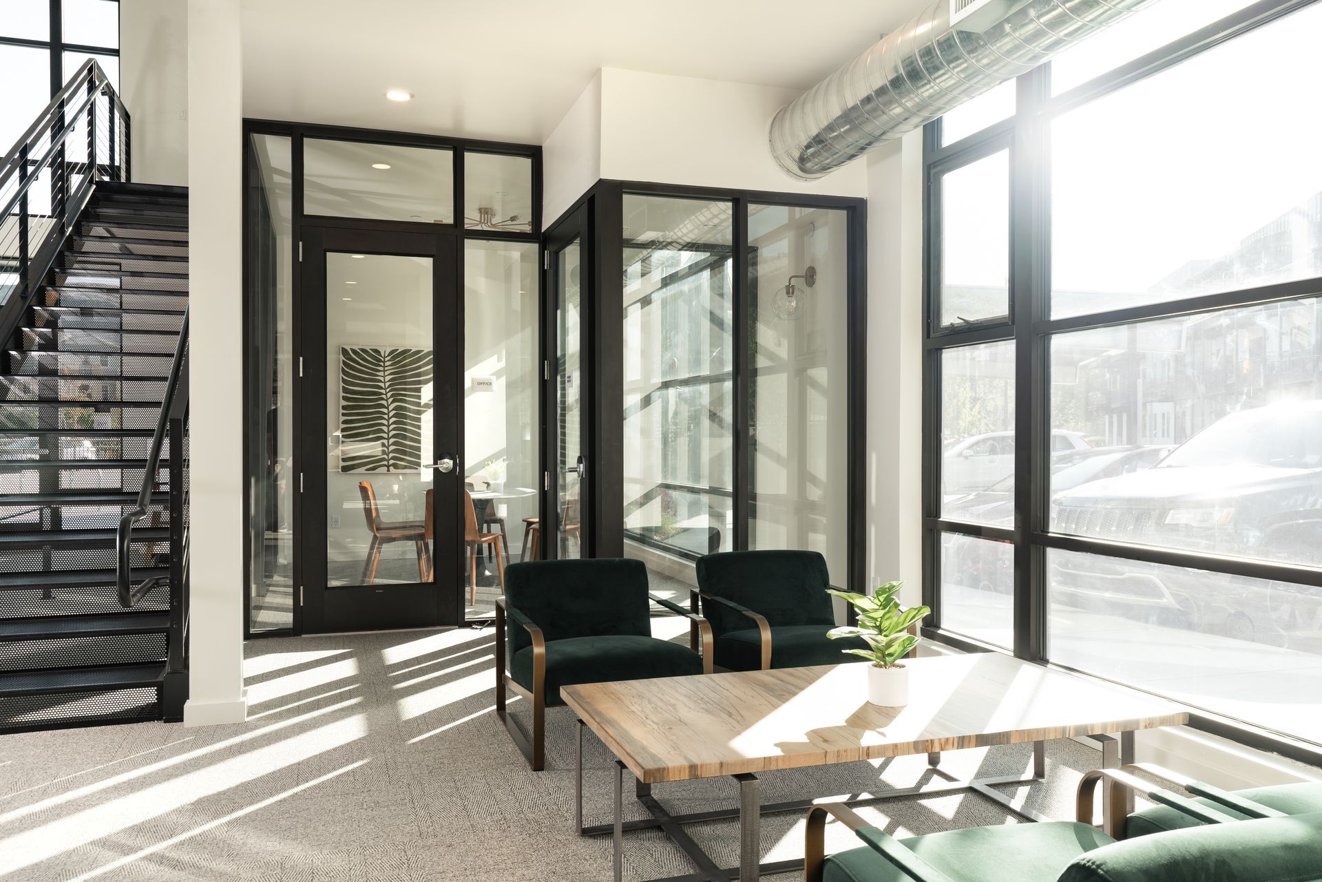 A living room with a table , chairs , and stairs.