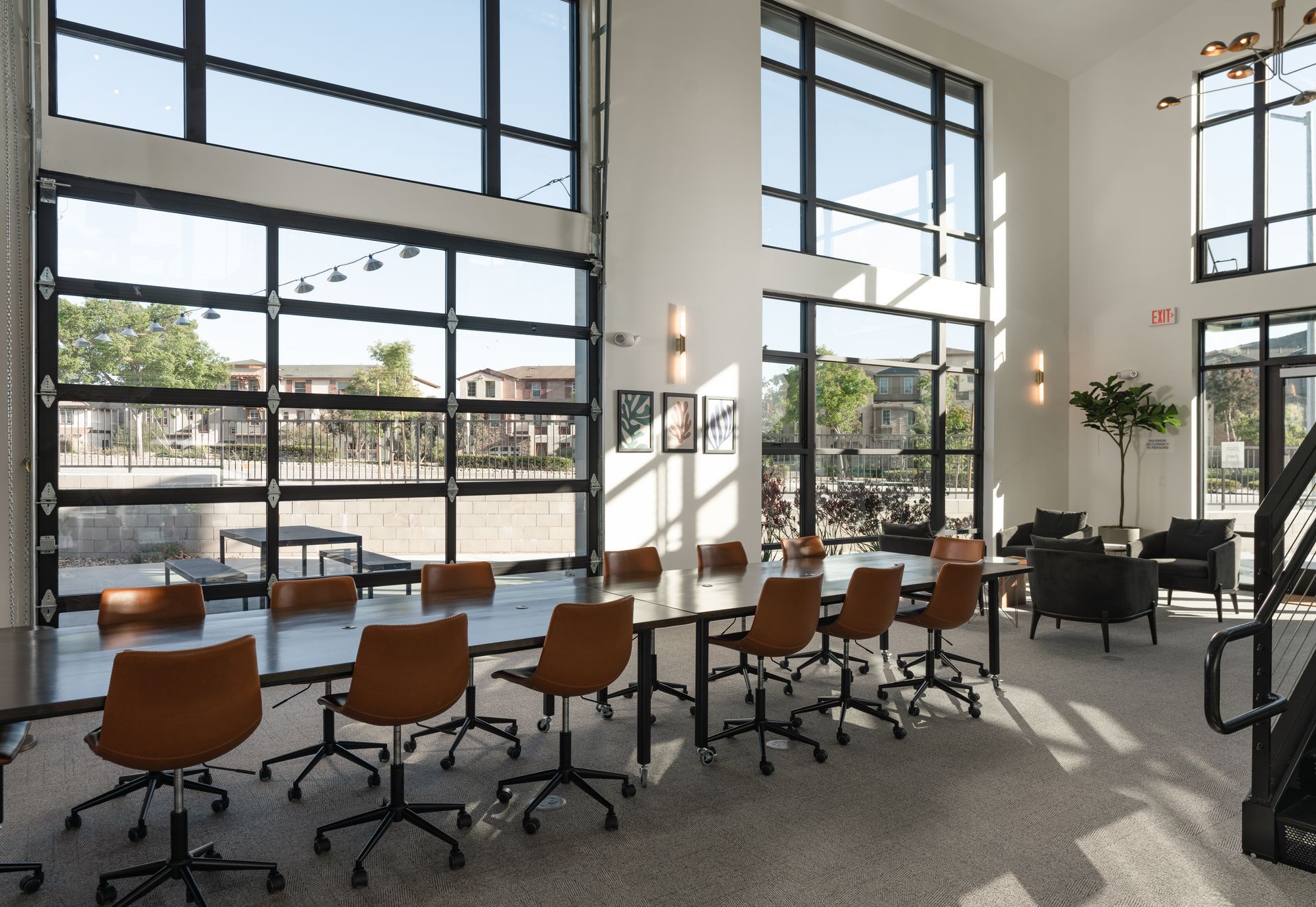 A large room with a lot of windows and tables and chairs
