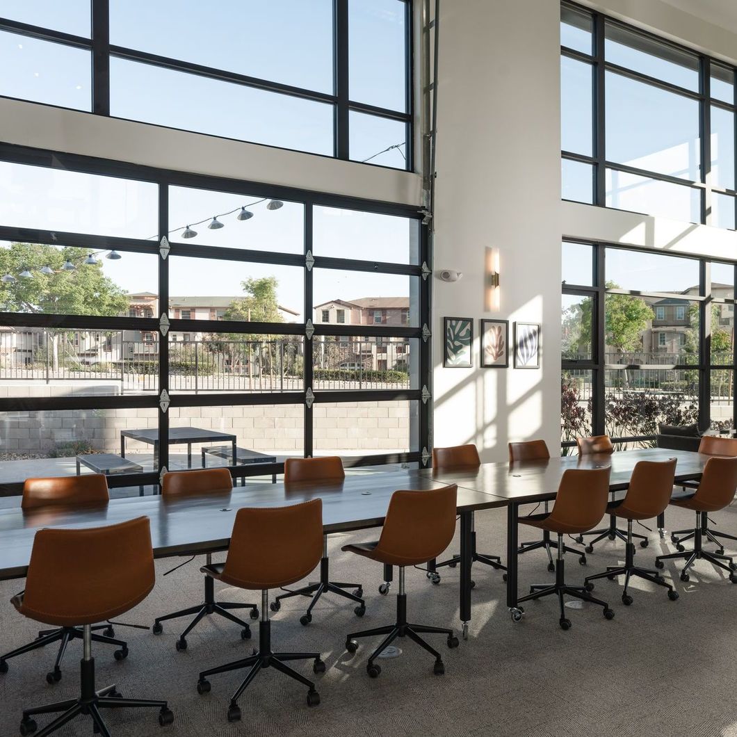 A conference room with a long table and chairs