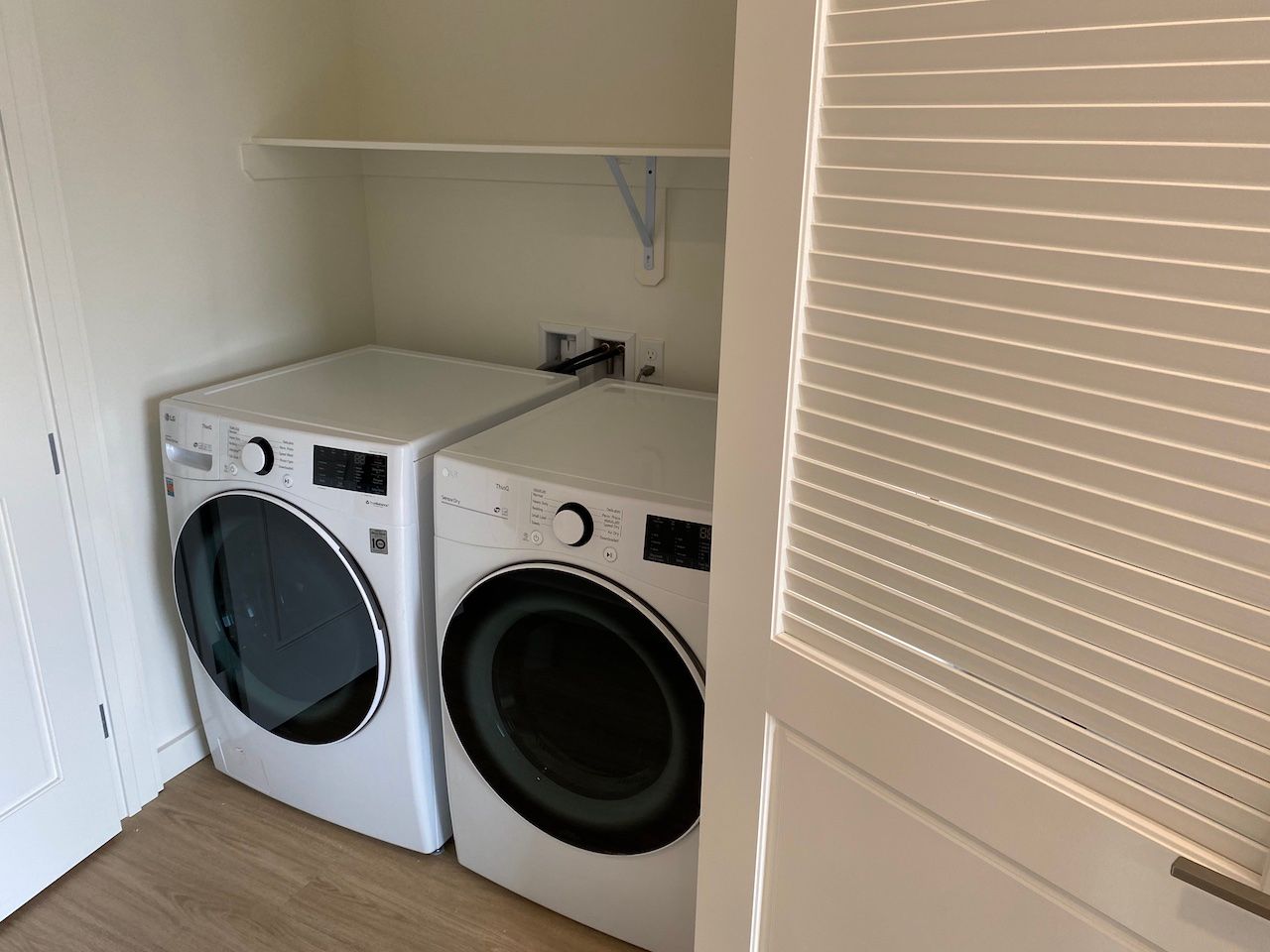 A washer and dryer are sitting next to each other in a laundry room.