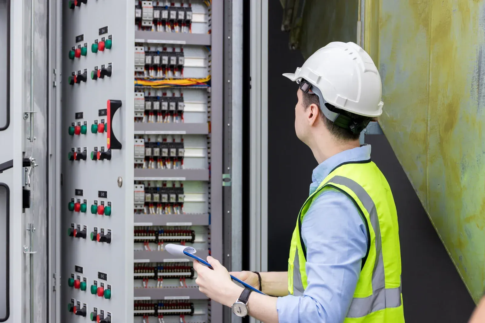 Solar and battery storage commissioning technician performing system validation checks on renewable.