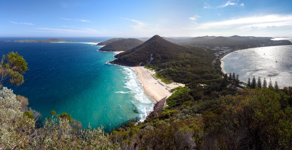 An Aerial View of a Beach and Ocean From a Cliff — Chad Warrington Plumbing In Nelson Bay, NSW
