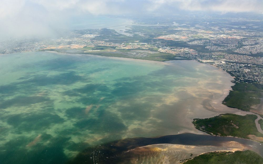 An Aerial View of a Large Body of Water With a City in the Background — Chad Warrington Plumbing In Shoal Bay, NSW