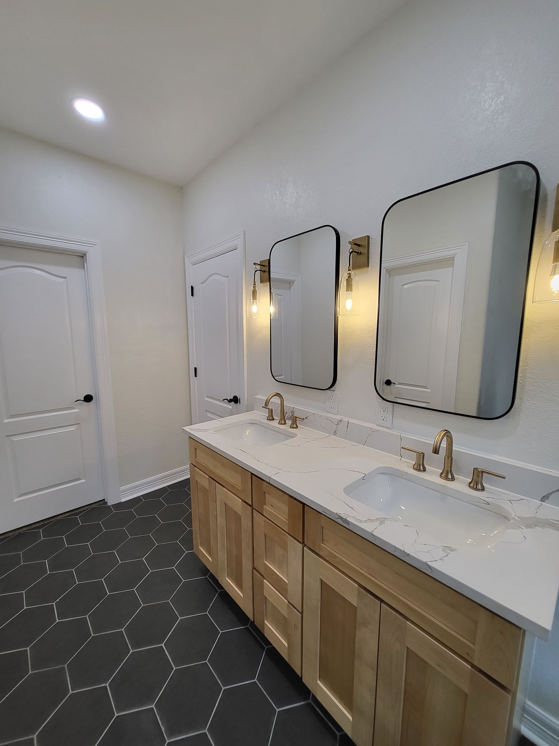 A bathroom with two sinks and two mirrors.