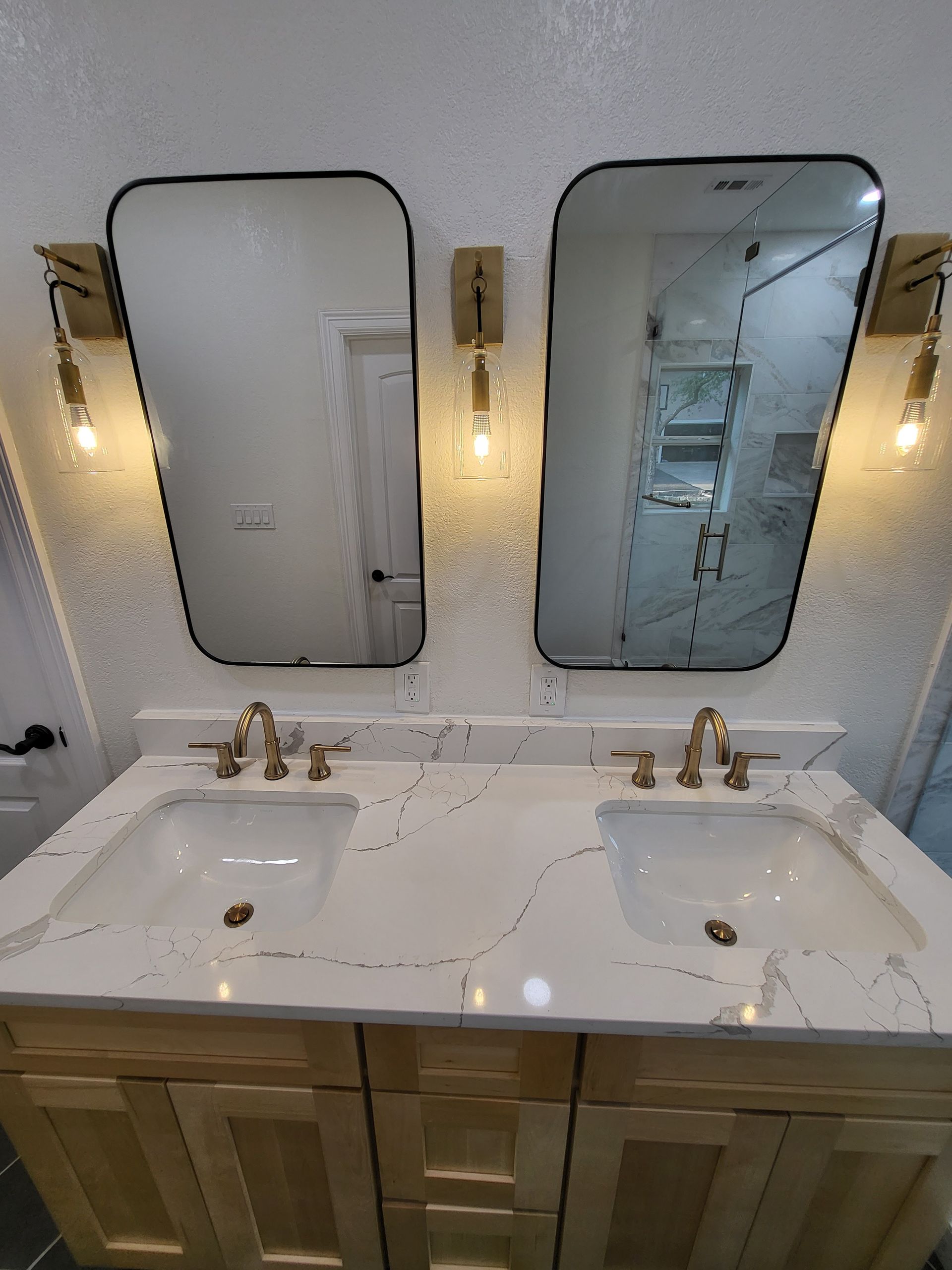 A bathroom with two sinks and two mirrors.