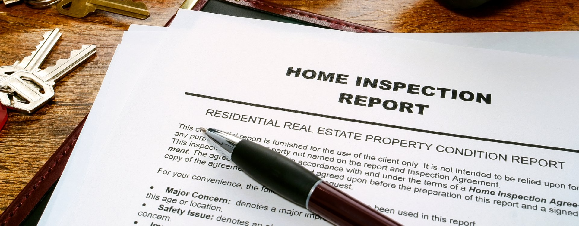 a pen is sitting on top of a home inspection report .