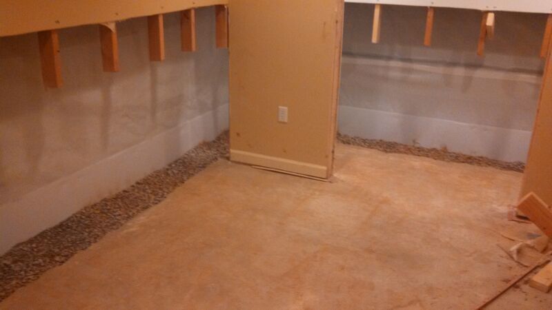 a room with a carpeted floor and a wooden wall .