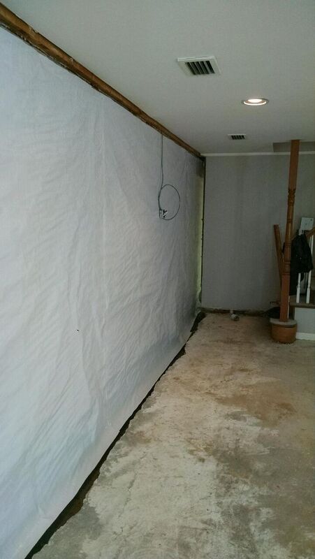 a room with a white vapor  barriers on the wall and a concrete floor