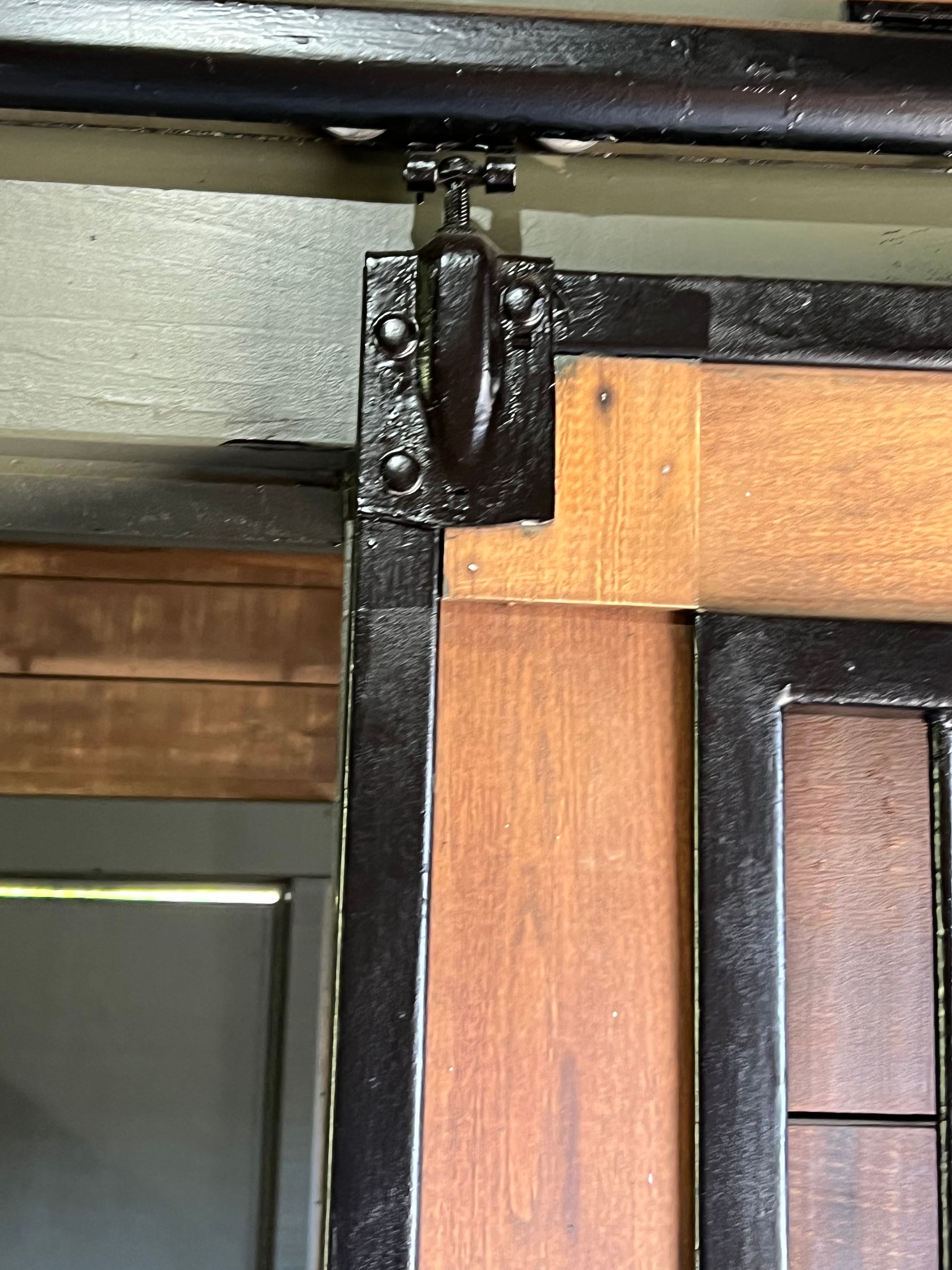 A close up of a wooden door with a metal frame.