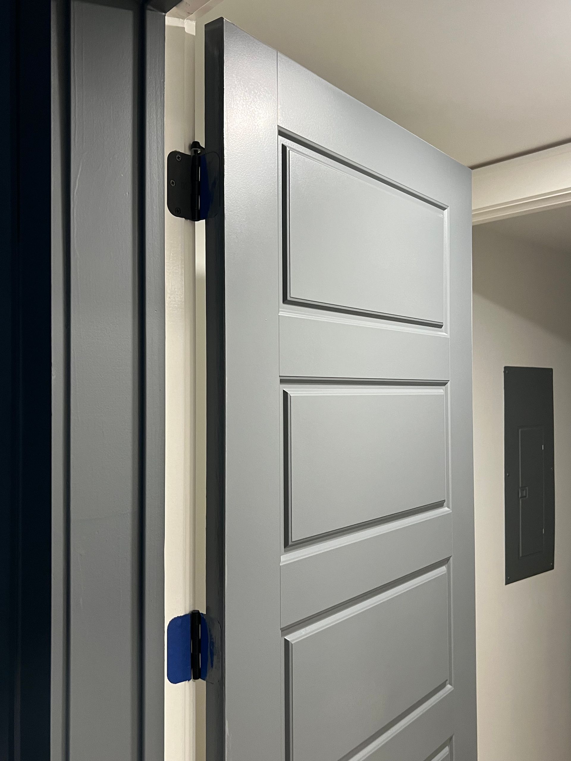 A close up of a gray door in a room.