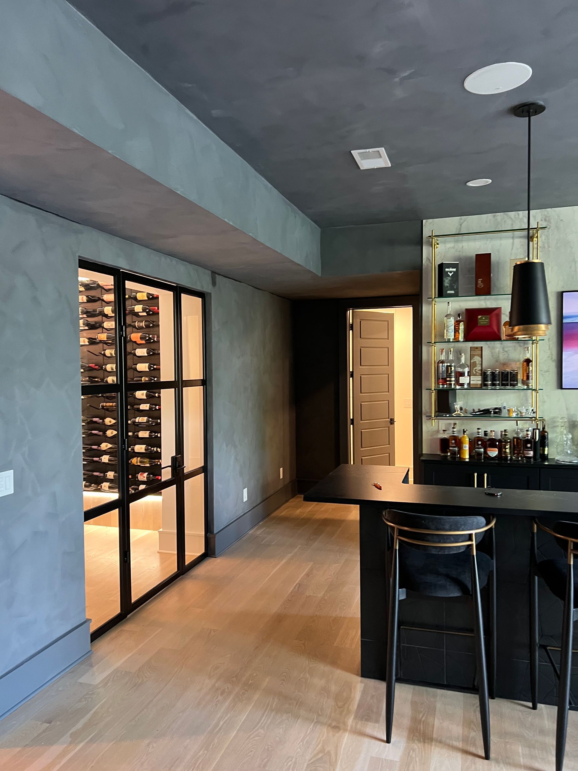 A room with a bar and a wine cellar