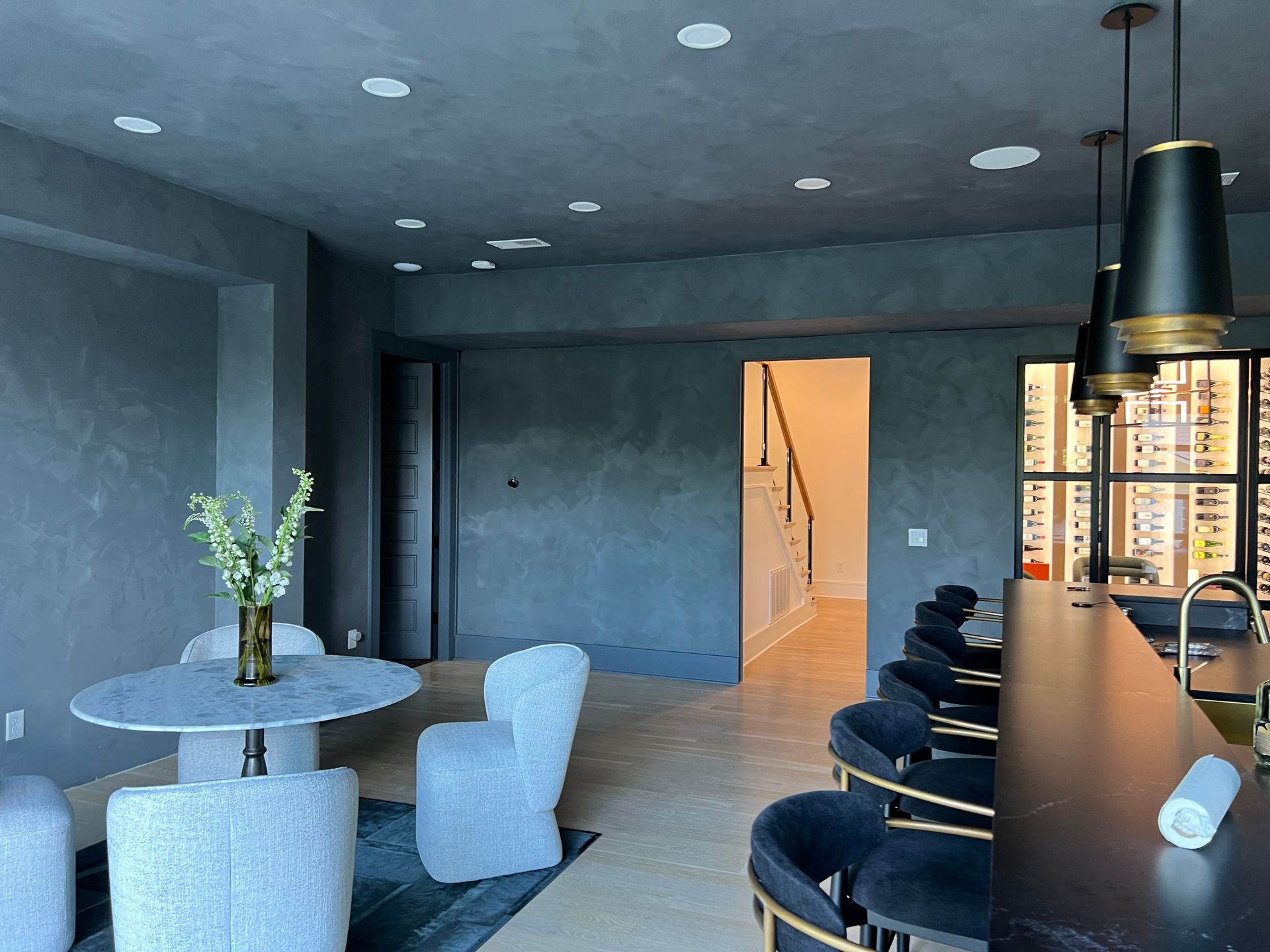 A dining room with a table and chairs and a bar