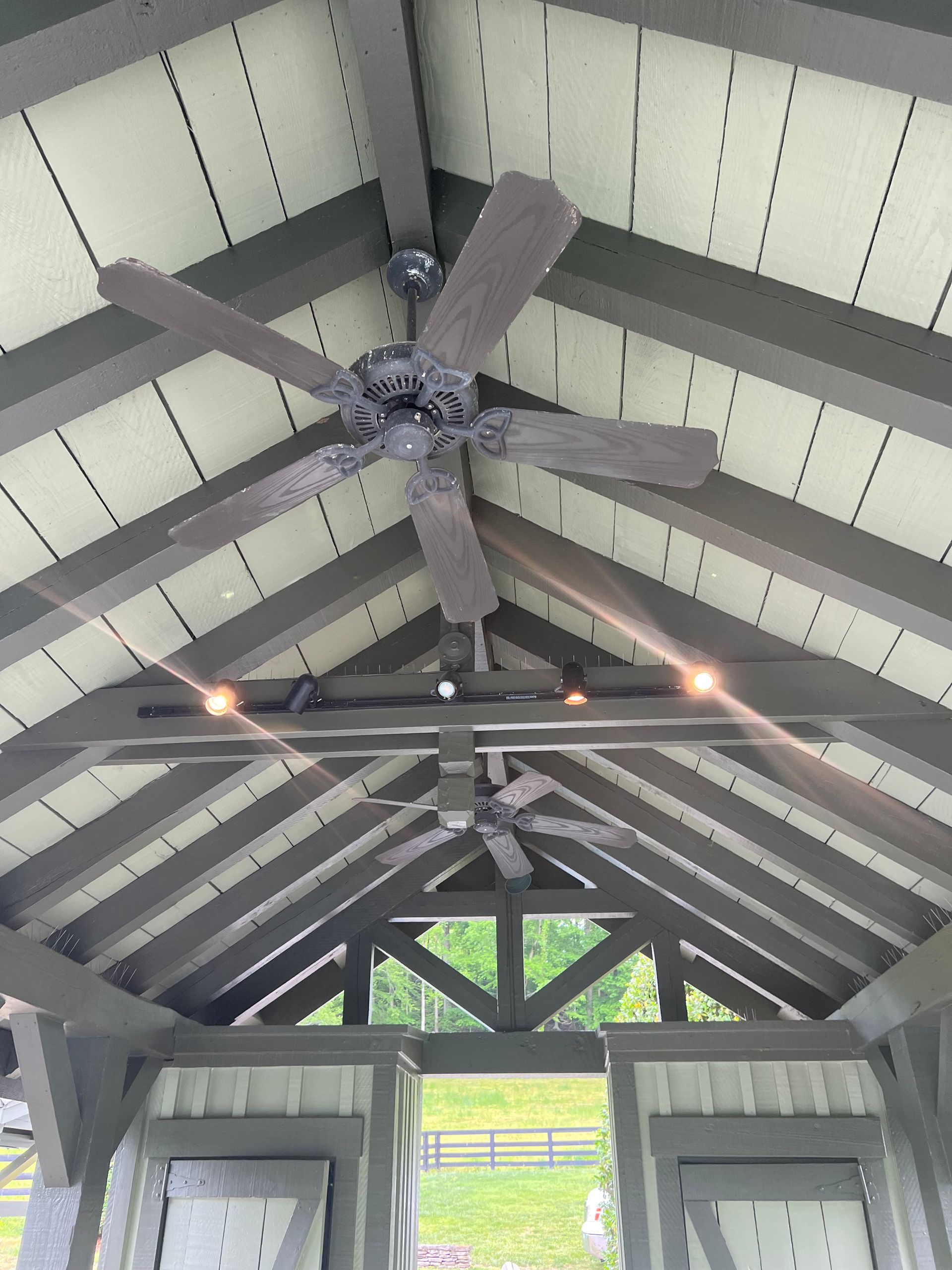 A ceiling fan is hanging from the ceiling of a building