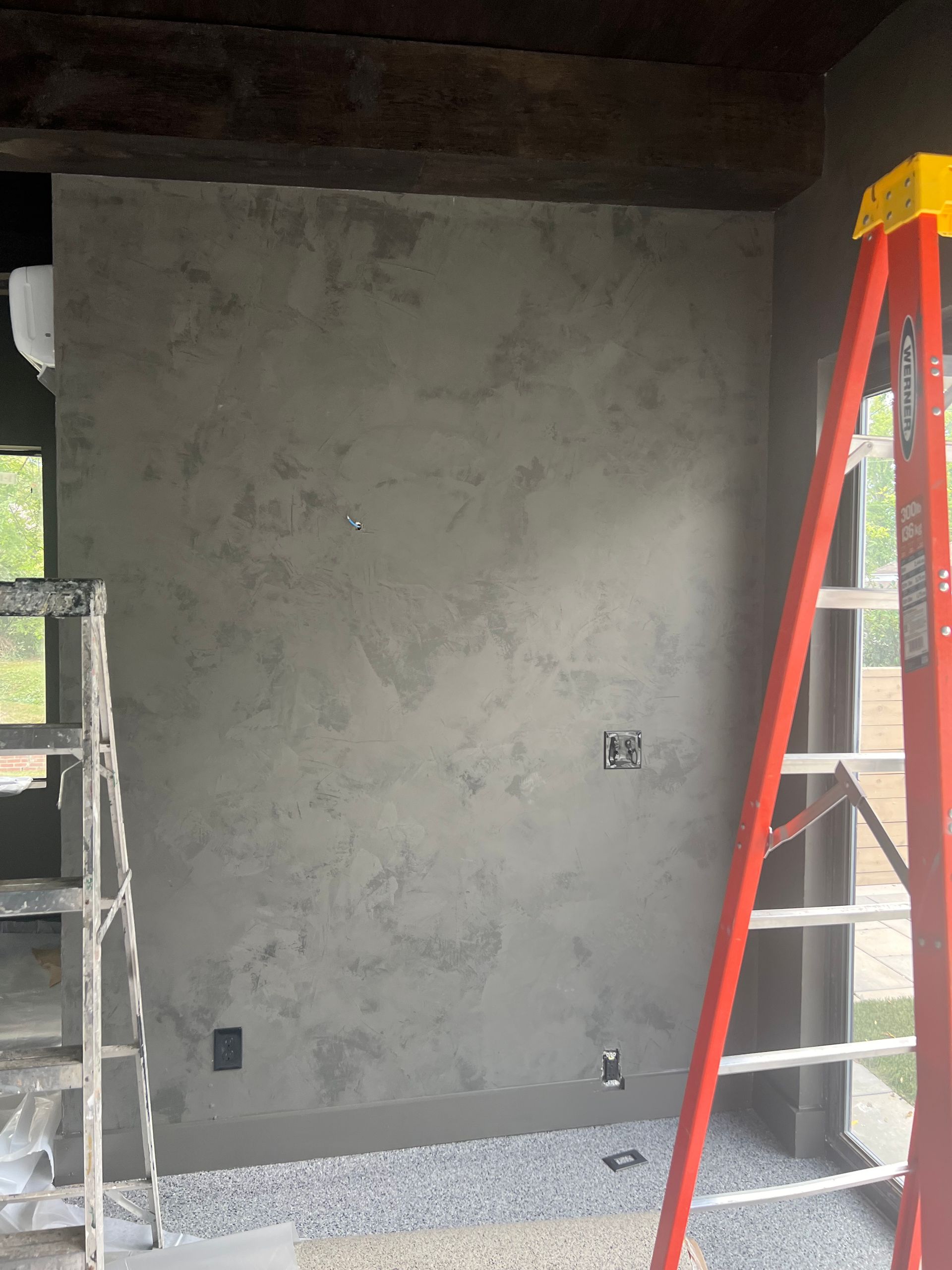 A ladder is leaning against a wall in a room.