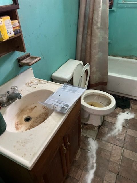 A bathroom with a sink toilet and bathtub