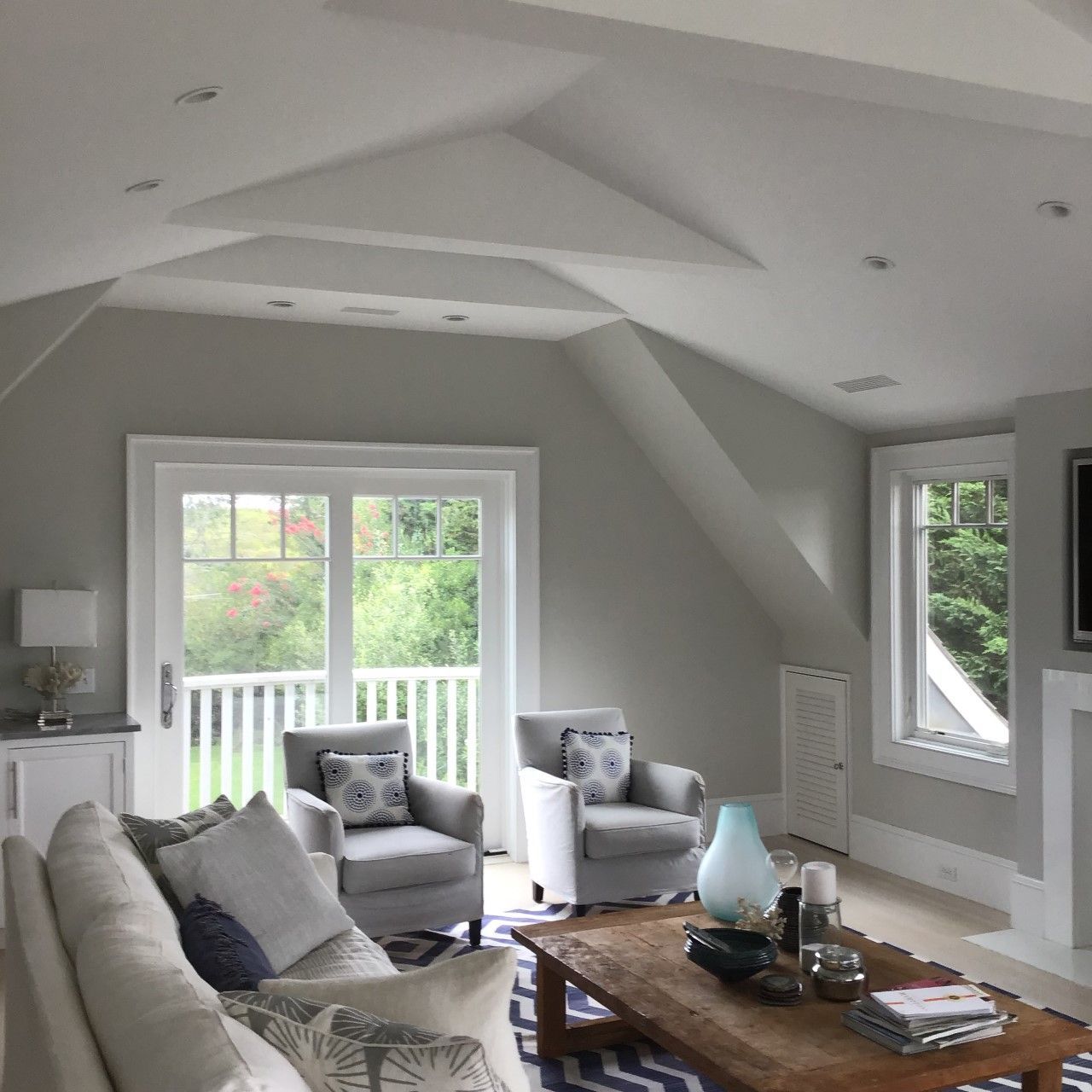 A living room with a couch two chairs and a coffee table
