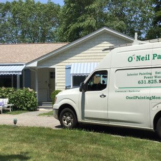 A white van is parked in front of a house.
