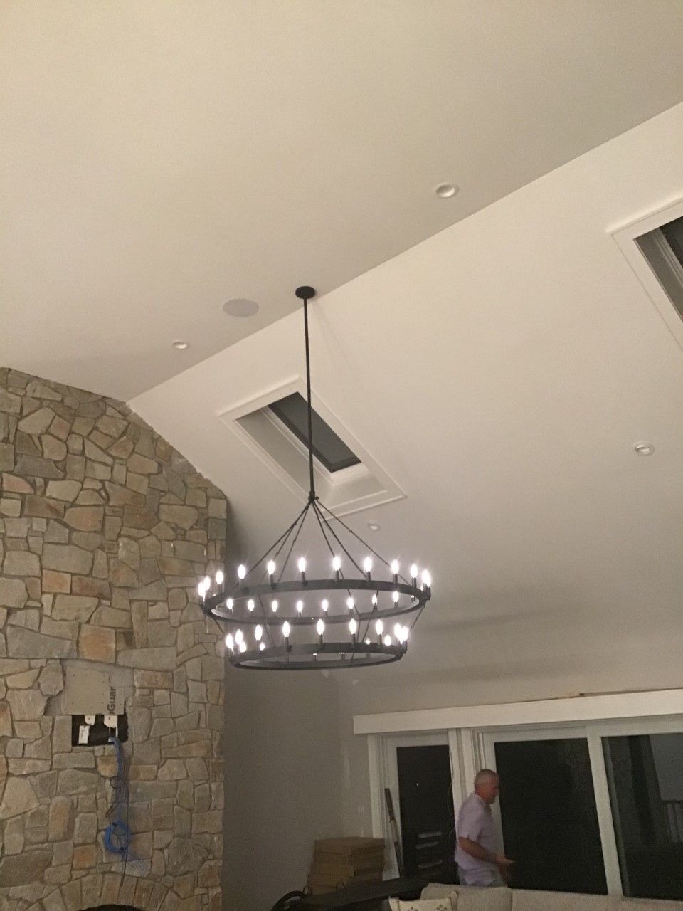 A large chandelier is hanging from the ceiling of a living room.