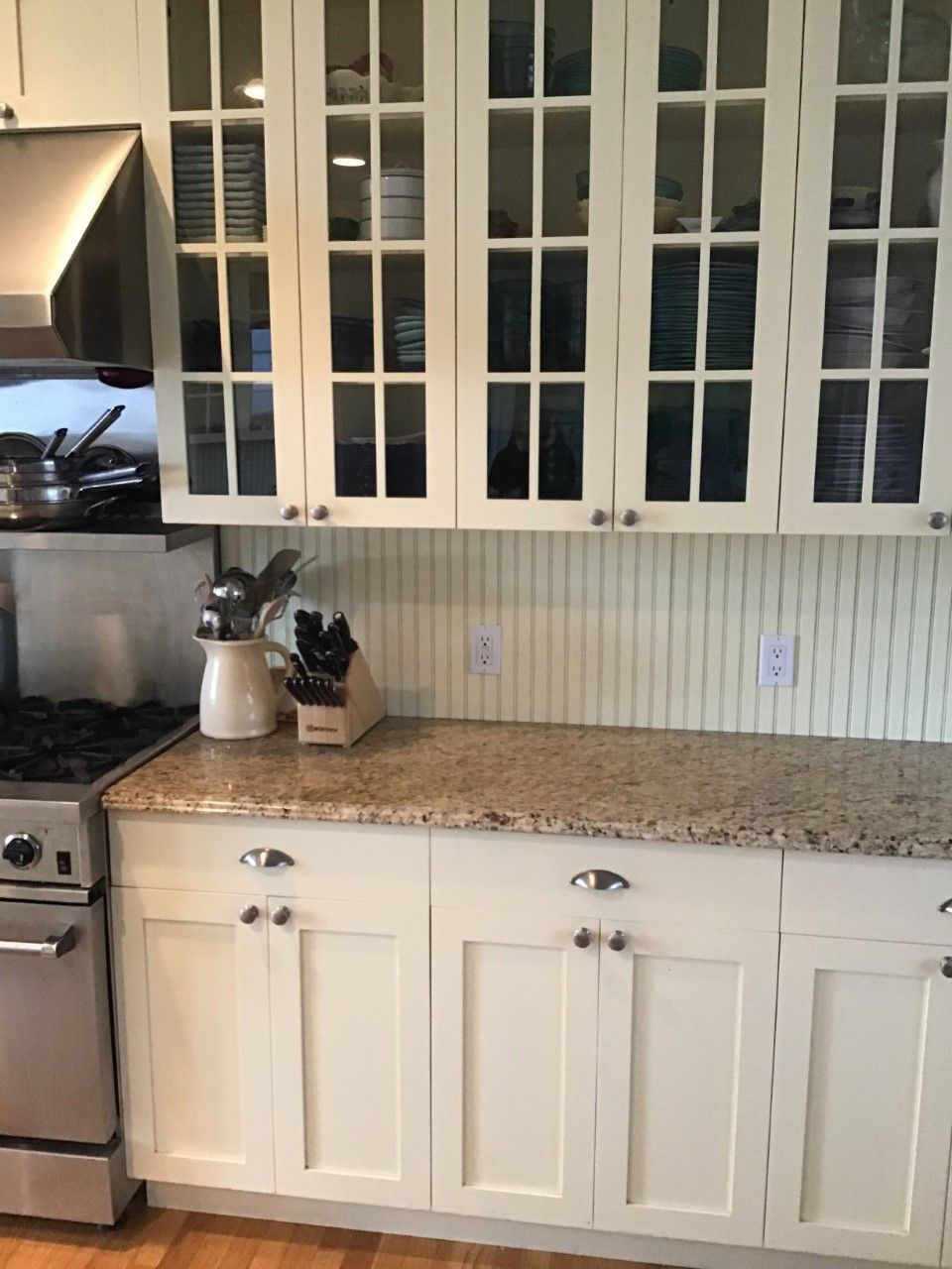 A kitchen with white cabinets and granite counter tops
