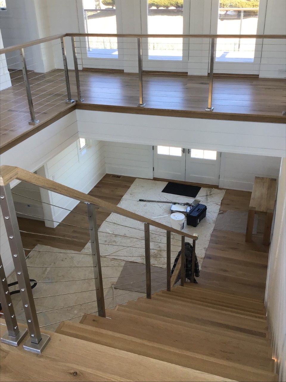 A view of a staircase from the second floor of a house.