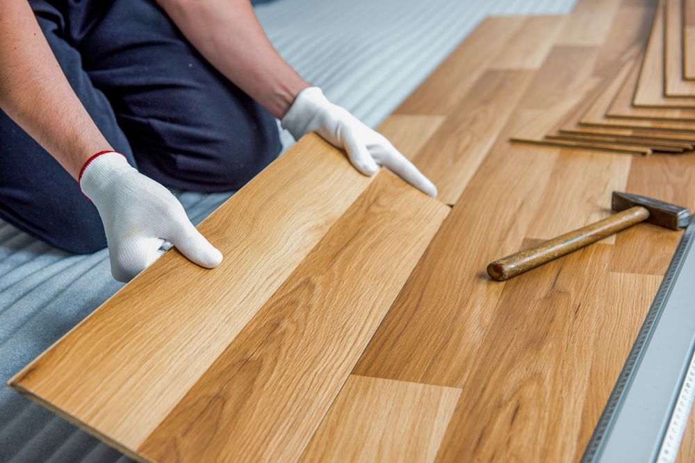Professional Worker Installing New Wooden Floor