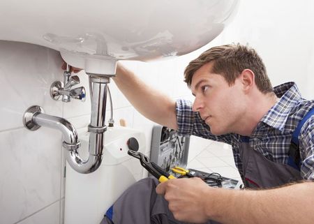 Plumber fixing a sink -  Sewer Cleaning in Amesbury, MA