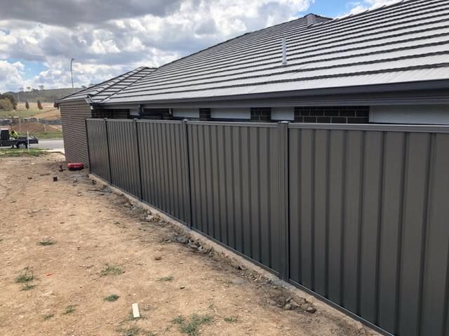 A fence is being built on the side of a house.