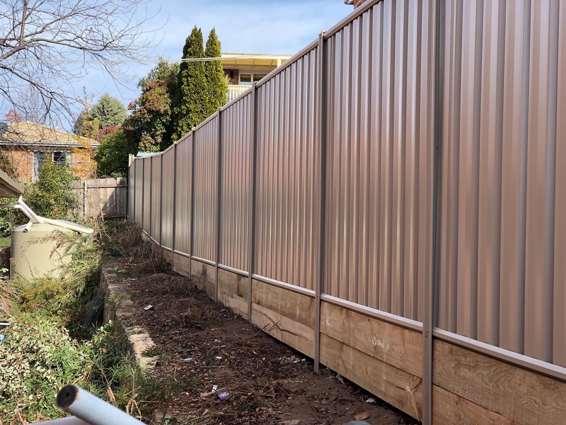 A brown fence is surrounded by a wooden fence.