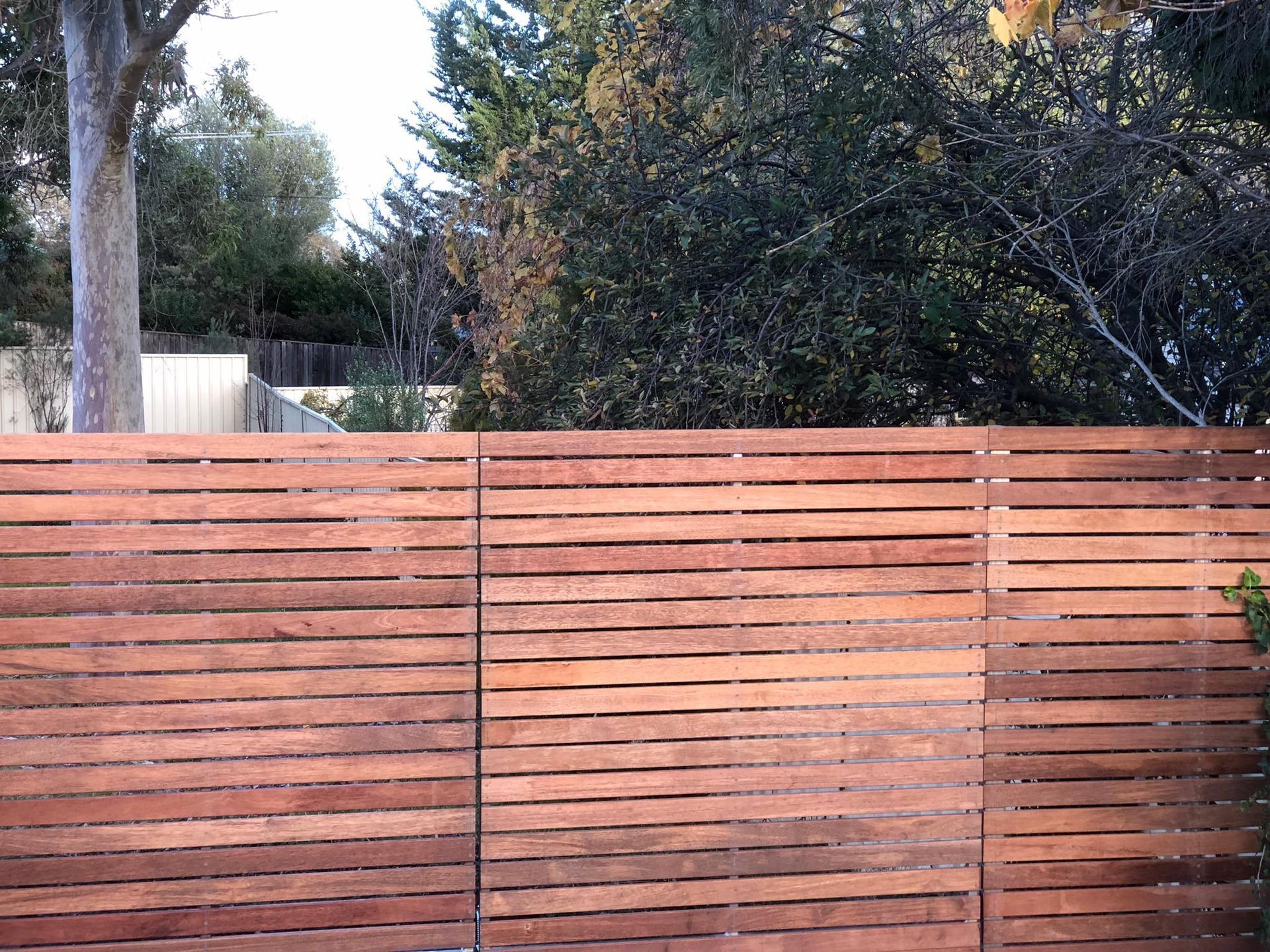 A wooden fence with trees in the background