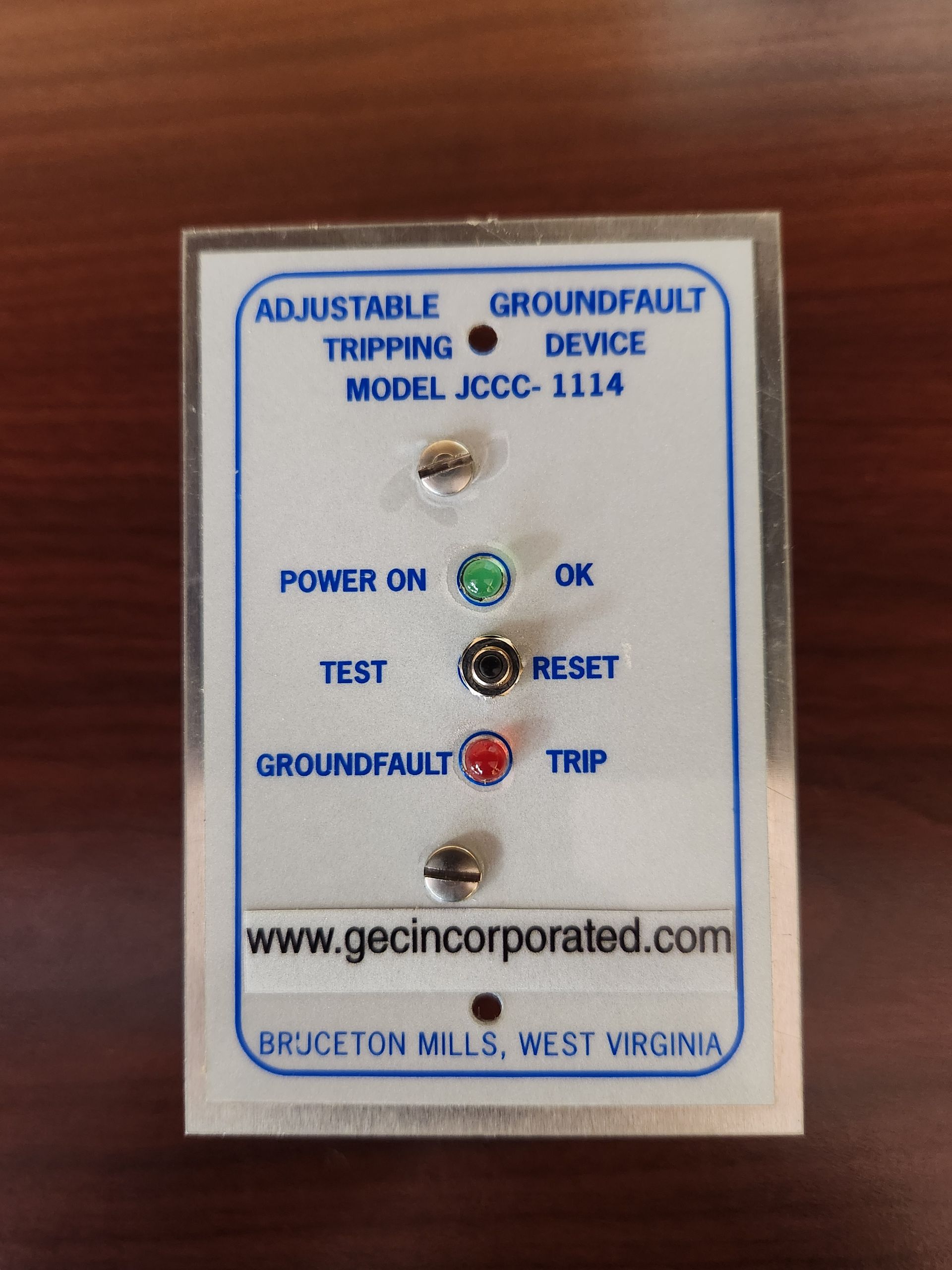 A man is working on an electrical box with a screwdriver.