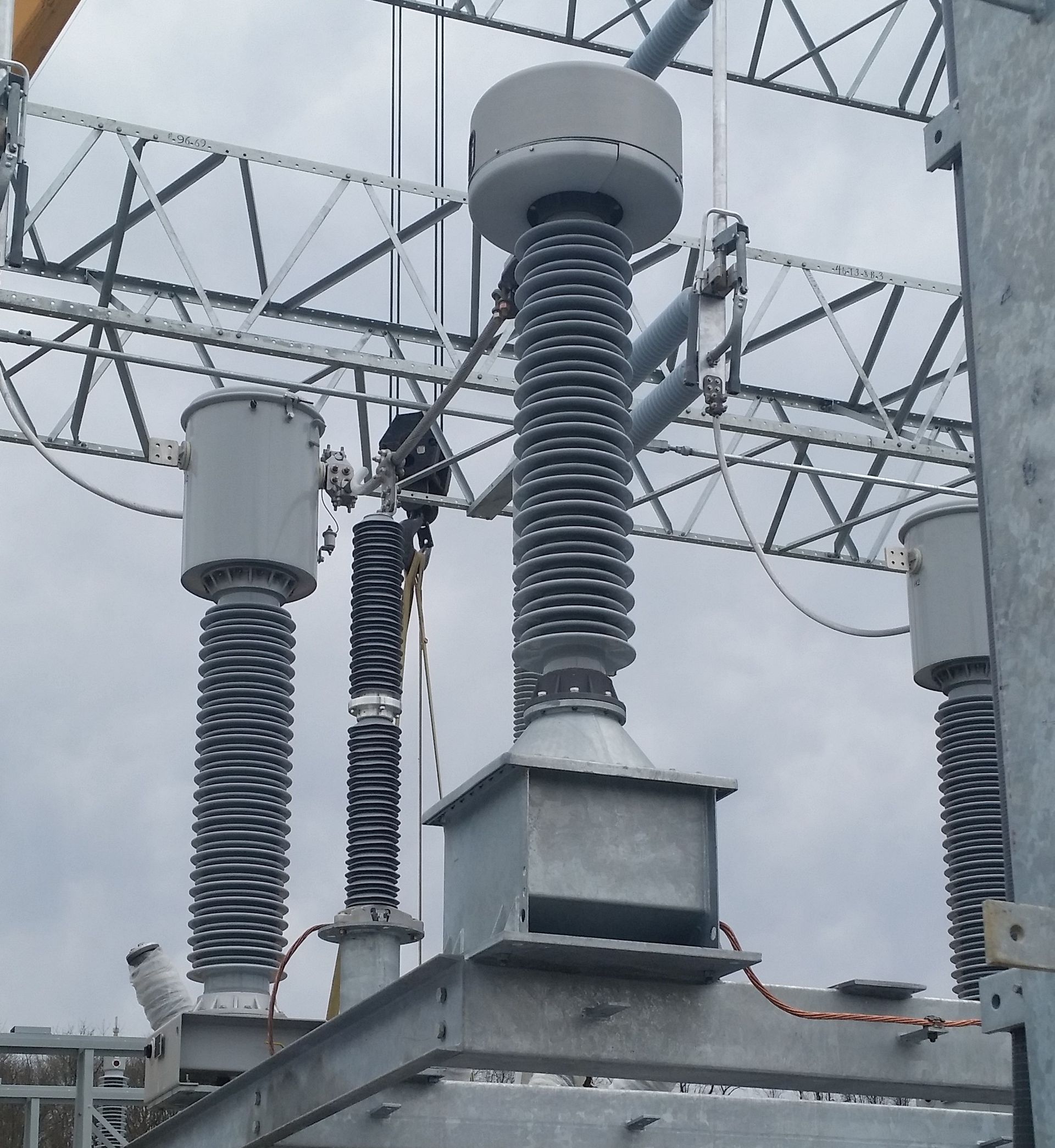 Two men are installing solar panels on the roof of a building.